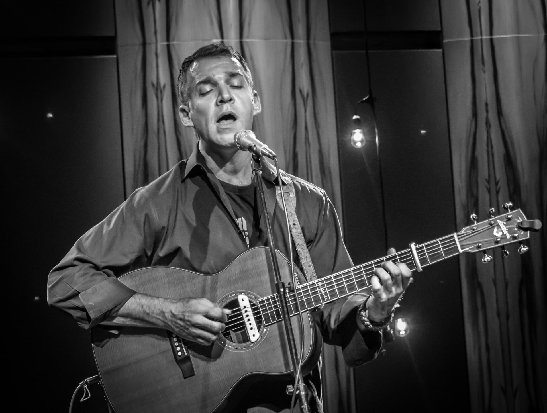 Sam Pacetti singing with his guitar