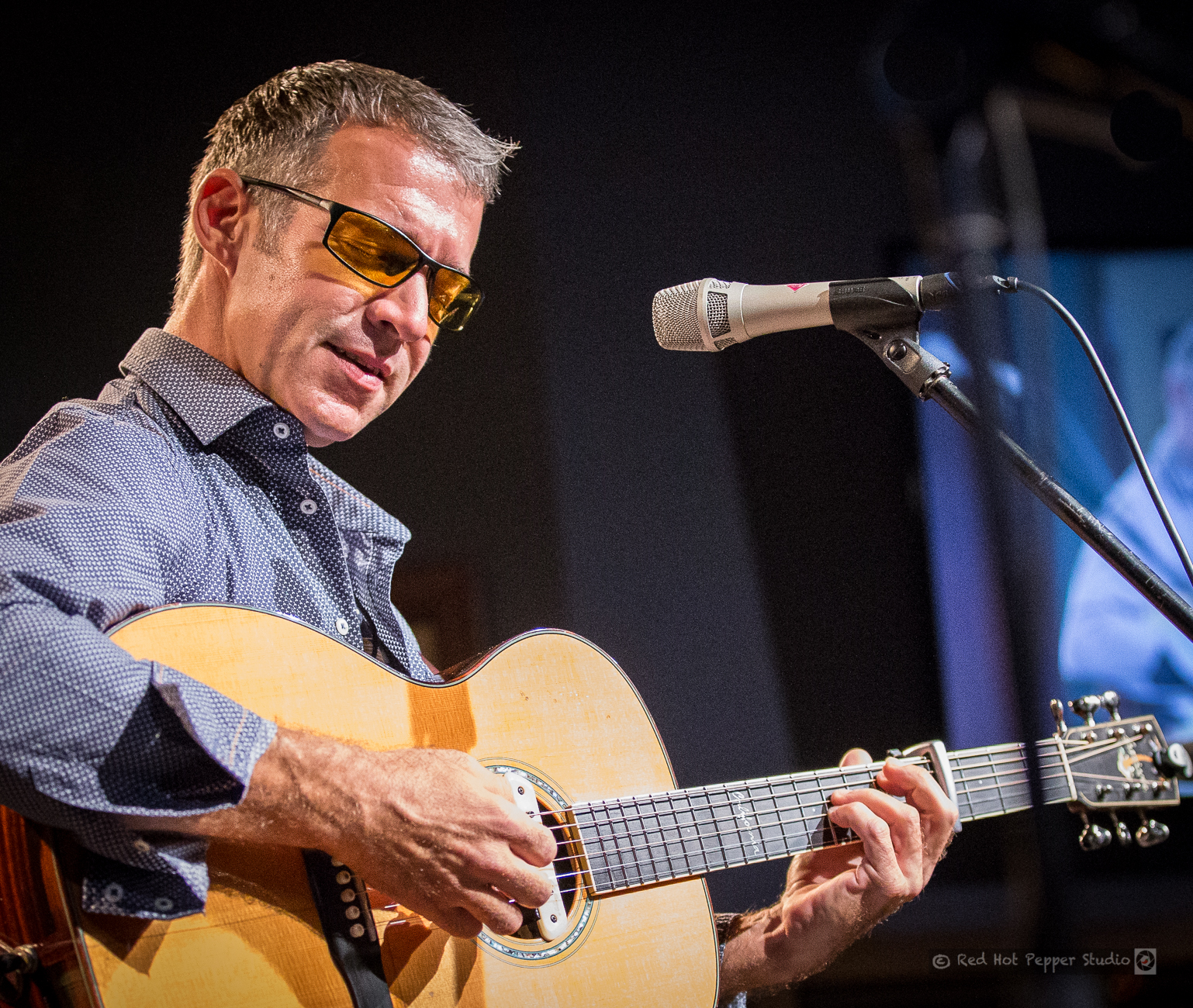 Sam Pacetti singing while playing guitar